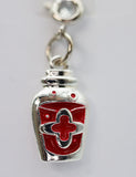 Silver and red pendant on a gray background