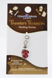 Traveler's Trinkets Healing Potion charm on Foam Brain Games packaging
