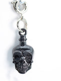 Silver skull pendant on a white background