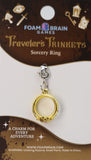 Gold ring charm on a Foam Brain Games card with branding and product details.