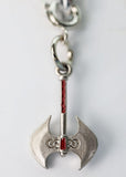 Silver axe-shaped keychain with a red gem on a light gray background