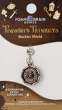 Buckler Shield charm on a Foam Brain Games card with branding and product details.
