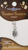 Silver angel wing charm on a Foam Brain Games 'Traveler's Trinkets' card.