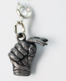 Silver fist charm with a chain on a white background
