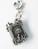 Silver pendant with eye design on a white background