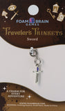 Sword charm on a Foam Brain Games packaging with decorative elements.