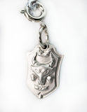 Silver pendant with a bull head design on a white background