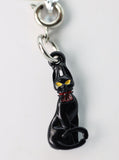 Black cat charm with yellow eyes and a red collar on a white background