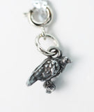 Silver parrot charm on a white background