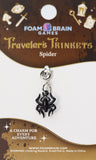 Black spider charm on a 'Traveler's Trinkets' card by Foam Brain Games.