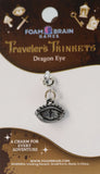 Dragon eye charm on Foam Brain Games packaging with branding and product details.