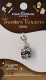 Silver charm on a Foam Brain Games card with decorative elements