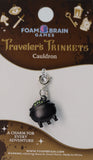 Foam Brain Games Traveler's Trinkets Cauldron charm on a packaging background