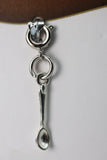 Silver spoon-shaped earring on a white background