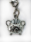 Silver bracelet with a detailed charm on a white background