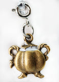 Bronze crab charm on a white background