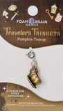 Pumpkin teacup charm on Foam Brain Games packaging with decorative elements.