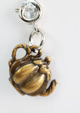 Gold crab charm with a clear crystal on a white background