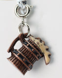Brown metal charm resembling a barrel with a white background