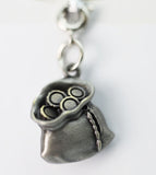 Silver paw print charm on a white background