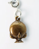 Bronze-colored pendant with a small pointed feature on a white background