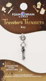 Key-shaped charm on a Foam Brain Games card with decorative elements.