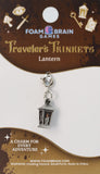 Lantern charm on Foam Brain Games packaging with branding and product details.