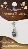 Traveler's Trinkets lock charm on Foam Brain Games packaging