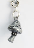 Silver mushroom-shaped pendant on a white background