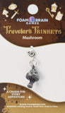 Mushroom charm on a Foam Brain Games packaging with decorative elements.