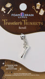 Silver charm on a Foam Brain Games card with decorative elements