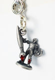 Silver charm with a design of a figure holding a large weapon on a white background