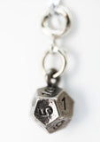 Silver die charm with number '1' on a white background