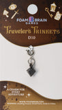 Foam Brain Games Traveler's Trinkets D10 charm on a display card with branding and product details.