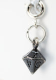Silver keychain with a dice charm on a white background
