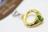 Gold keychain with a green accent on a white background