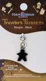 Black meeple charm on a Foam Brain Games card with branding and product details.