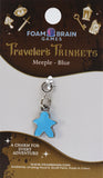 Blue meeple charm on a Foam Brain Games card with decorative elements.
