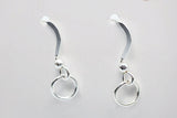 Pair of silver earrings on a light gray background
