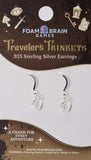 Silver earrings on a Foam Brain Games packaging with decorative elements and text.