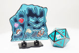 Blue and black character figure with a stand and a metal polyhedral dice on a white background