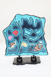 Decorative plaque with cartoonish designs on a stand against a white background