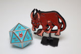 Metallic blue polyhedral dice and red fantasy creature figurine on a white background
