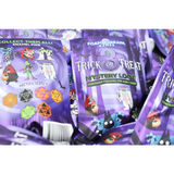 Purple packaging of 'Trick or Treat' mystery loot with enamel pins and dice, featuring Halloween-themed graphics.