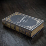 Decorative book titled 'Deadwood 1876' on a dark wooden surface