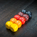 Colorful dice with star patterns on a wooden surface