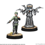 Two miniature figures on round bases, one resembling a human in green uniform and helmet, the other a metallic robot with multiple arms.