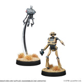 Two miniature figures on stands with a white background