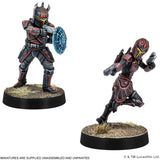 Two miniature figures in futuristic armor on black bases with a white background.