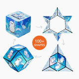 A penguin-themed 3D folding puzzle shown in multiple configurations on a light gray background, with arrows connecting the shapes and an orange circle that reads '100+ SHAPES'. The cube, star, and polyhedron views all feature blue icy artwork with white and light blue penguins.